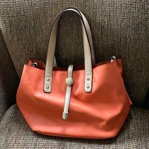 Woman’s orange purse